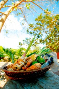 A collection of Thai herbs with plai in the foreground