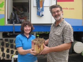 Fred giving Bronwen a thank you present - a cucumber growing in a banana trunk - one of the cool ideas they came across in their travels